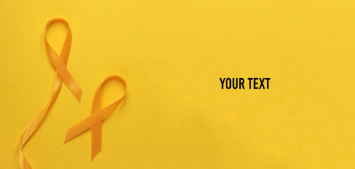 Yellow ribbons, childhood cancer awareness day symbol. Copy space for your text
