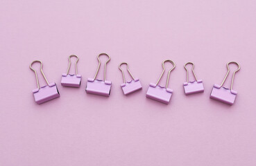 Set of stationery paper binders on purple background