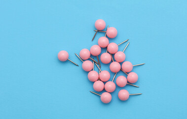 Set of stationery paper pins on blue background