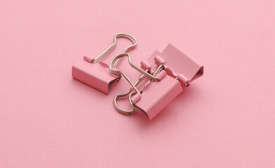 Pink paper binders on a pink background