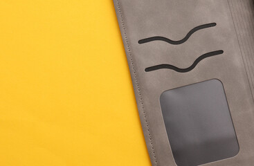 Leather cardholder on a yellow background