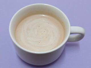 Malaysian Teh Tarik or Hot Milky Drink Served in a Traditional Cup. Mug of Frothy Hot Drink with Subtle Foam Texture