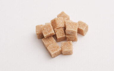 Cubes of cane brown sugar on white background