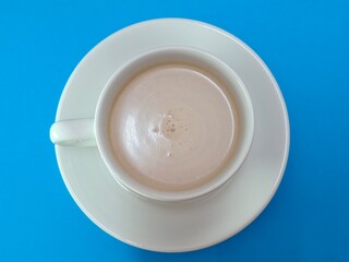 Malaysian Teh Tarik or Hot Milky Drink Served in a Traditional Cup. Mug of Frothy Hot Drink with Subtle Foam Texture