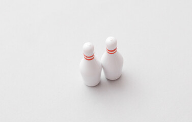 Miniature bowling pins on gray background. Conceptual photo