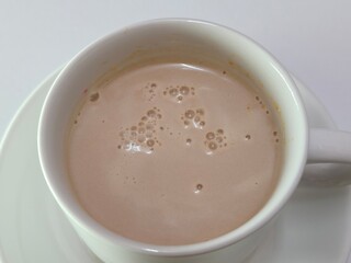 Malaysian Teh Tarik or Hot Milky Drink Served in a Traditional Cup. Mug of Frothy Hot Drink with Subtle Foam Texture