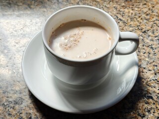 Malaysian Teh Tarik or Hot Milky Drink Served in a Traditional Cup. Mug of Frothy Hot Drink with Subtle Foam Texture
