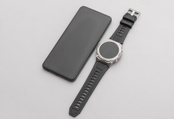 Modern gadgets. Smartphone and Smart watch on a gray background
