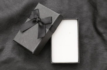 Open Gift box on black leather background