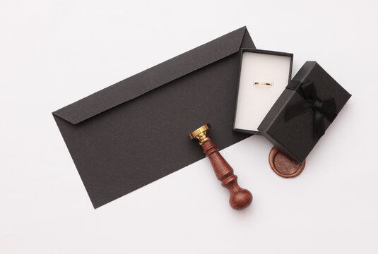 Wedding proposal. Envelope with vintage stamp and gift box with gold ring on white background - Powered by Adobe