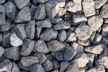 Close-up view of grey crushed aggregate stones, perfect for construction, landscaping, or decorative backgrounds.