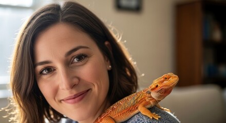 Happy Woman Posing with Her Adorable Bearded Dragon Pet on Her Shoulder in a Bright Indoor Portrait