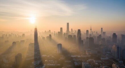 Sunrise over a hazy city skyline featuring a distinct towering building casting a long shadow Golden sun rays illuminate the dense urban landscape