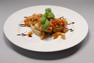 A plate with food placed on a gray background, meal presentation in a simple setting and reflecting everyday dining culture and culinary traditions.