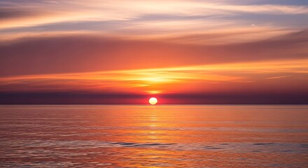 Naklejka premium Vibrant Sunset Over Calm Ocean Water Reflecting Fiery Orange and Purple Hues