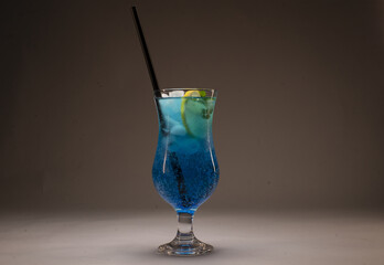 Alcoholic or non alcoholic cocktail in a stylish glass on a gray background, photographed in studio conditions as part of food and beverage product shooting.