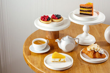 berry tartlets on white plates and tea
