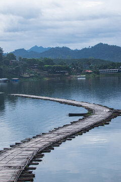 Wooden pier extending into calm mountain lake waters
