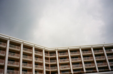 Overcast sky above a pink hotel building with white balconies in Maui.