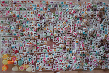 Naklejka premium A colorful assortment of letter beads and fruit-shaped charms