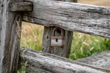 Aged lock on weathered wooden fence
