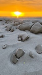 Warm golden sunset light caresses abstract sand shapes on a quiet beach, glowing softly in tranquil evening tones by the sea.