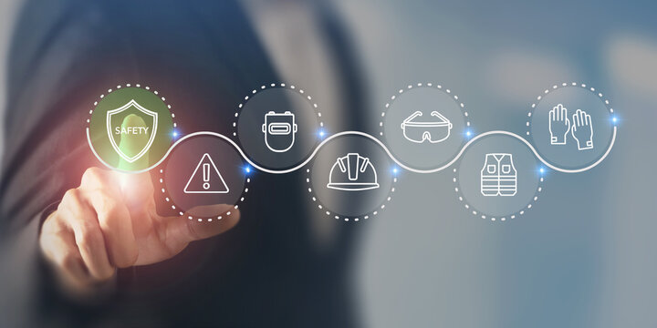 Workplace Safety Concept. Virtual interface displaying safety related icons; a shield, warning sign, hard hat, goggles, gloves and vest. Enhancing workplace safety, hazard prevention, PPE management.