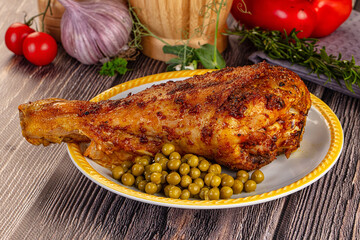 Baked turkey drumstick served green peas