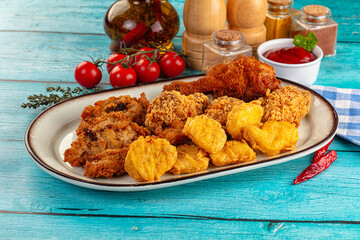 Golden crispy fried chicken mix - wings, drumsticks, nuggets and strips