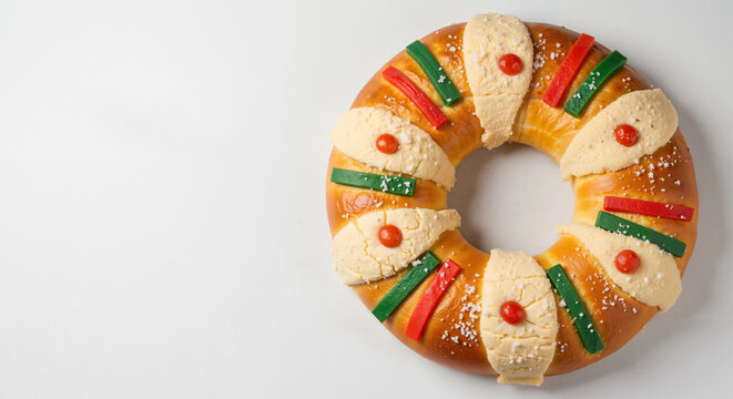 Rosca de reyes, festive bread ring, top view on a white background, copy space