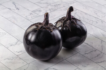 Raw round black big eggplant