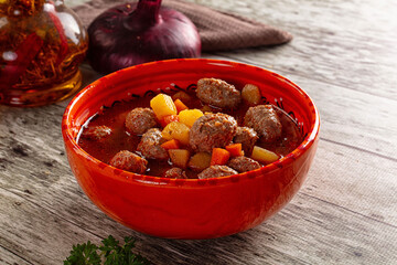 Tomato soup with meatballs and vegetables