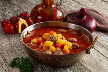 Tomato soup with meatballs and vegetables