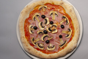 Pizza with mushrooms close-up served as a meal, showing baked food presentation and reflecting popular cuisine. Fast food culture.