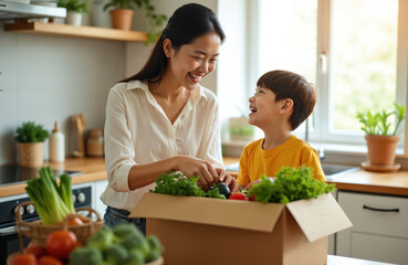 Asian mother, son happily unpack fresh groceries in bright modern kitchen. Sort vegetables, produce from cardboard box, smiling at. Scene shows family bonding, healthy eating habits. Food wholesome,