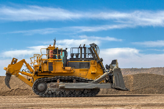dozer driving on dirt road, in a diamond mine , open pit mine Africa, big Track rollers
