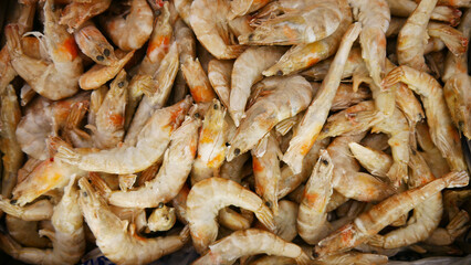 A heap of many frozen king prawns