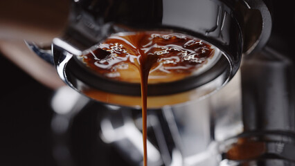 pull espresso shot with bottomless portafilter on a professional coffee machine