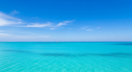 Fototapeta premium A serene view of turquoise ocean water under a clear blue sky with scattered white clouds above it ai generated