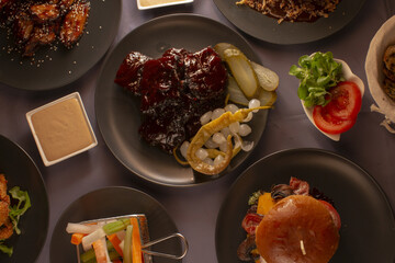 An assortment of beautifully arranged dishes displayed on colorful plates, featuring a wide variety of foods