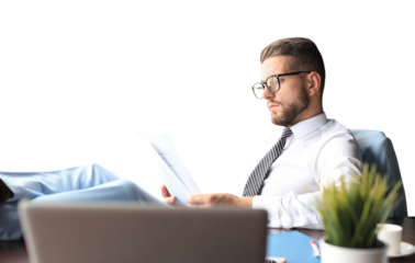 Handsome businessman sitting with legs on table and examing documents on a transparent background