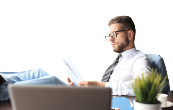 Handsome businessman sitting with legs on table and examing documents on a transparent background
