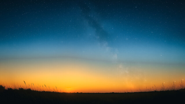 An awe-inspiring vista unfolds at dusk, as the radiant sun bids farewell below the horizon. The landscape is transformed into a mesmerizing expanse of twilight, inviting serenity.