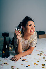 Woman celebrating christmas and new year's eve with champagne