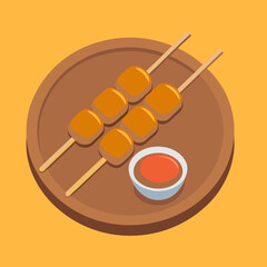 Satay skewers and peanut sauce on a wooden plate