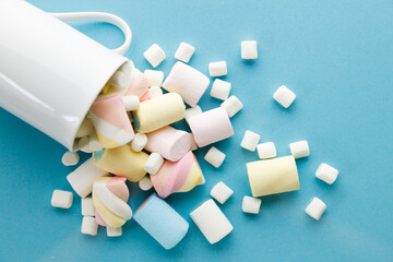 Colorful marshmallows on a vibrant blue background.
