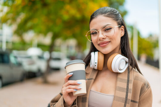 Young pretty woman at outdoors with happy expression