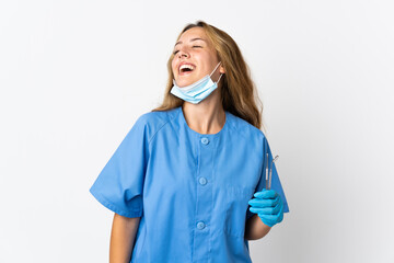 Woman dentist holding tools isolated on white background laughing