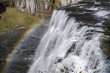 Rainbow. Upper Mesa Falls is a waterfall on the Henrys Fork in the Caribou-Targhee National Forest. Fremont County, Idaho. Henrys Fork (Snake River tributary). Basalt 
