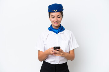 Airplane stewardess caucasian woman isolated on white background sending a message with the mobile